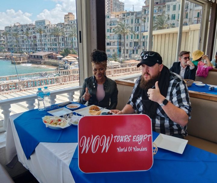 Couple enjoying a local seafood meal with sea view at a restaurant along the Alexandria Corniche, Egypt