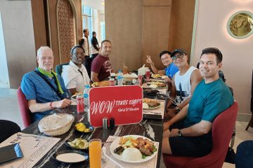 Travelers enjoying traditional Egyptian cuisine together at a local restaurant during a shared dining experience with WOW TOURS EGYPT.