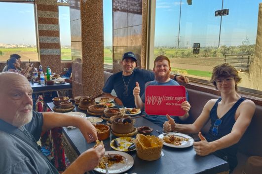 Tourists enjoying traditional Egyptian food at a local restaurant during a food experience with WOW Tours Egypt.