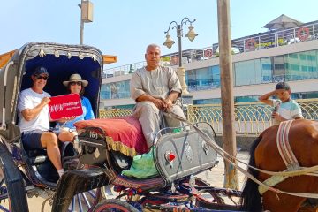 Tourists enjoying a traditional horse carriage ride in Luxor, exploring the city with WOW Tours Egypt.