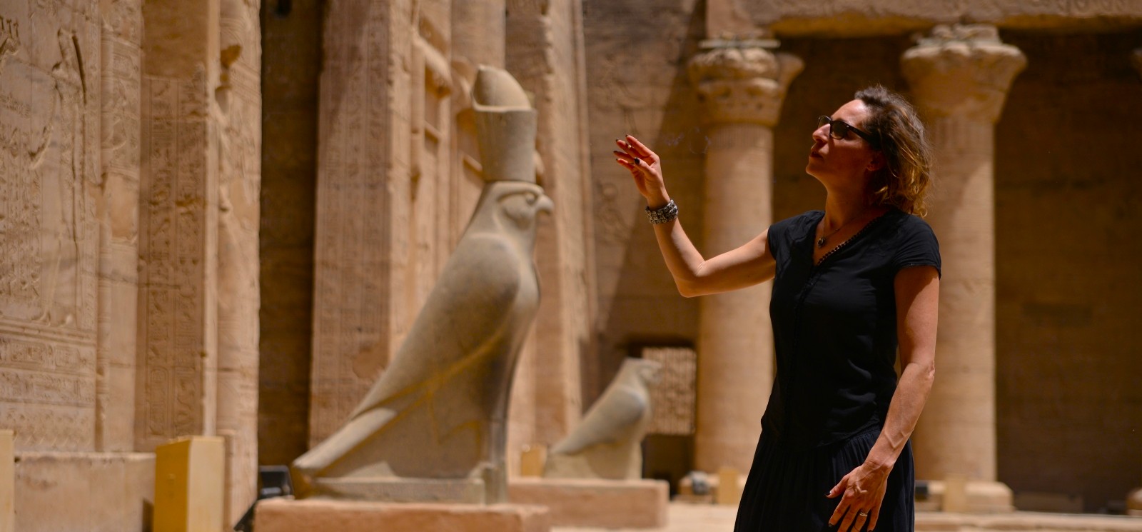 A lady stands in awe inside the Temple of Horus at Edfu.. // Luxor Background (9) // Aswan Background (10)