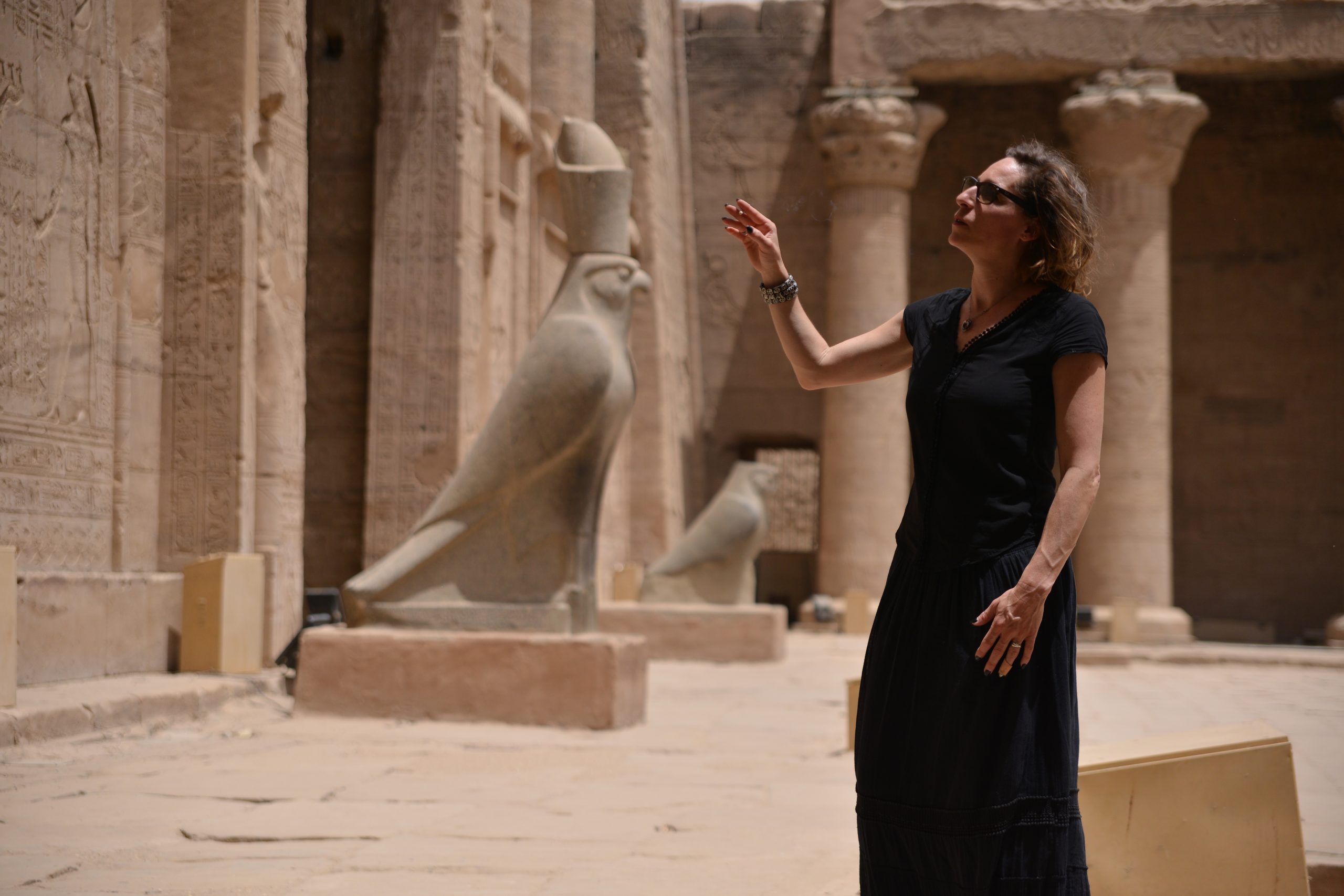 A lady stands in awe inside the Temple of Horus at Edfu.