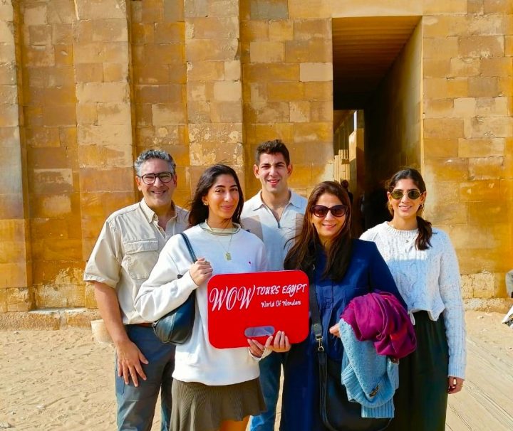 Happy travelers with WOW TOURS EGYPT standing at the entrance of the Step Pyramid in Saqqara, Egypt