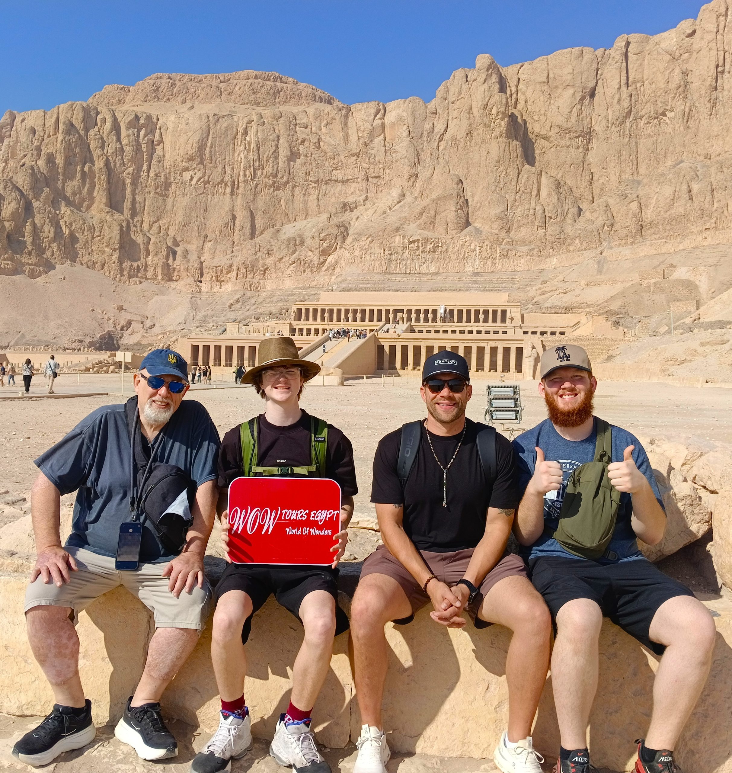 Friends enjoying a sunny morning with Hatshepsut Temple framed by the rugged cliffs of Deir el-Bahari.