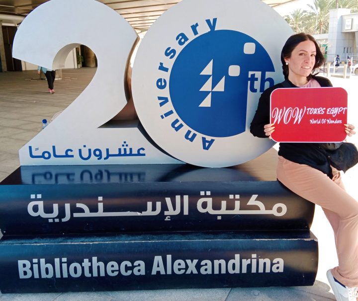 Guest posing beside the Bibliotheca Alexandrina anniversary monument in Alexandria.