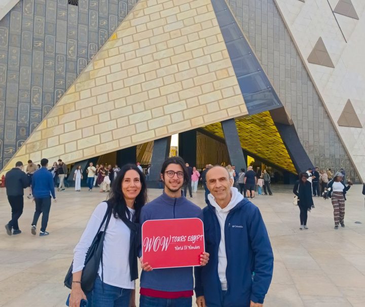 Guests posing at the Grand Egyptian Museum entrance in Giza with WOW Tours Egypt.
